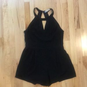 Black romper with open back and lace detail
